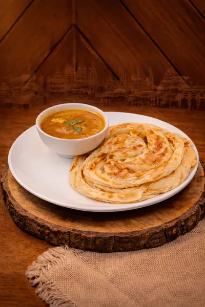 Bun Parotta served with salna curry at Parotta Palace — soft, pillowy South Indian flatbread